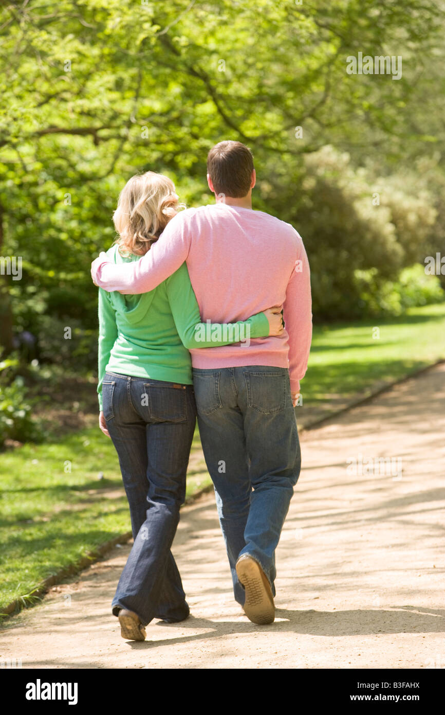 Couple walking on path arm in arm Stock Photo