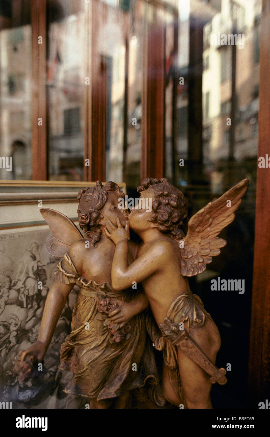 GENOA: A SCULPTURE OF 2 KISSING ANGELS BY A SHOP WINDOW Stock Photo