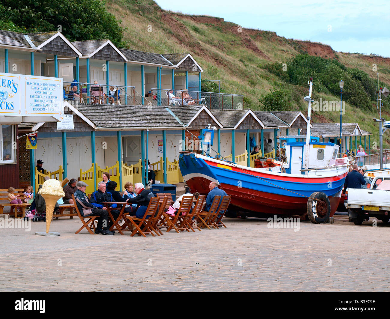 Alfresco cafe,beach chalets and a boat with wheels,on the promenade at