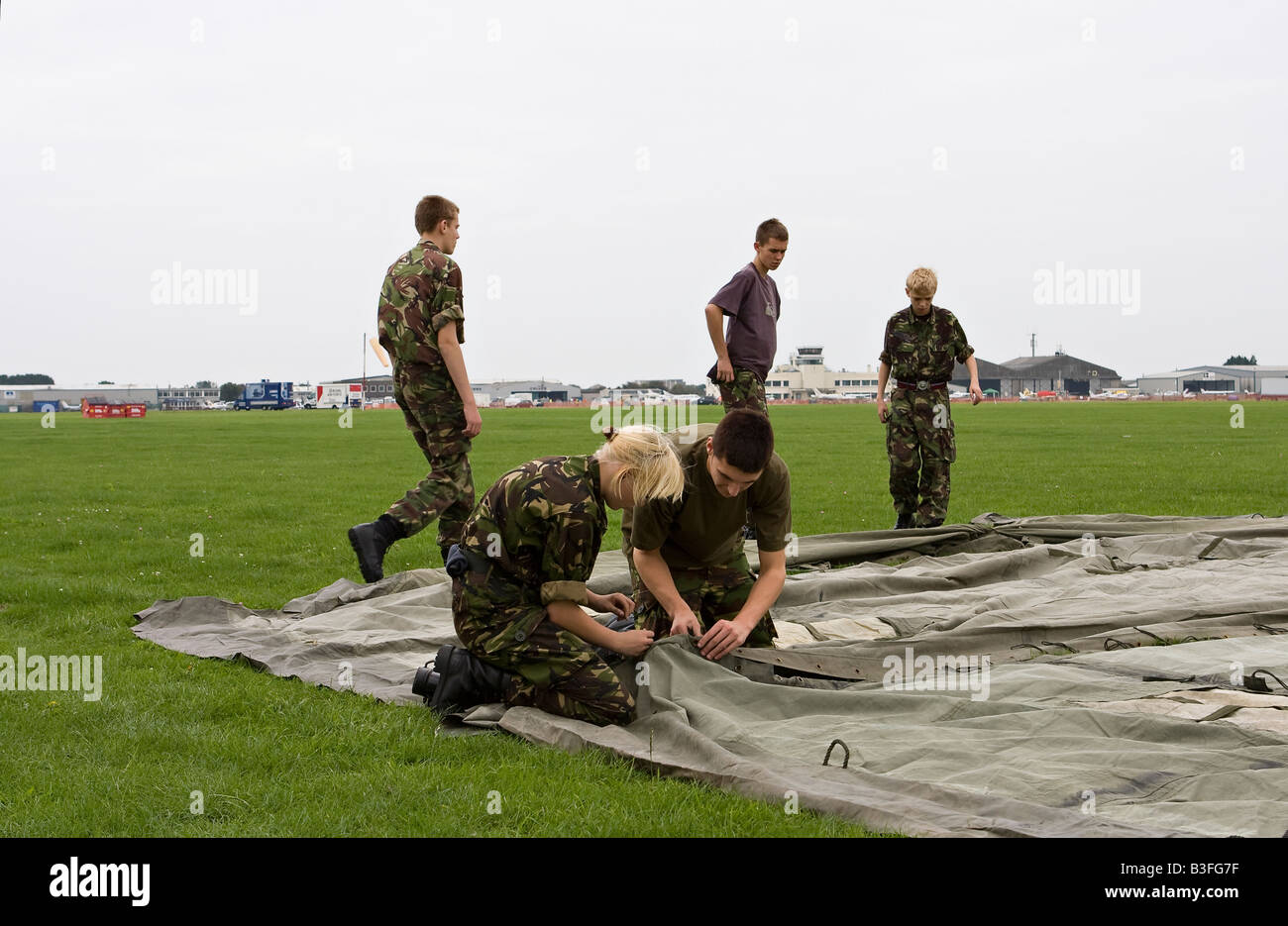 Young army cadets putting up tents at RAFA Charity Airshow Shoreham Airport Sussex England Stock Photo