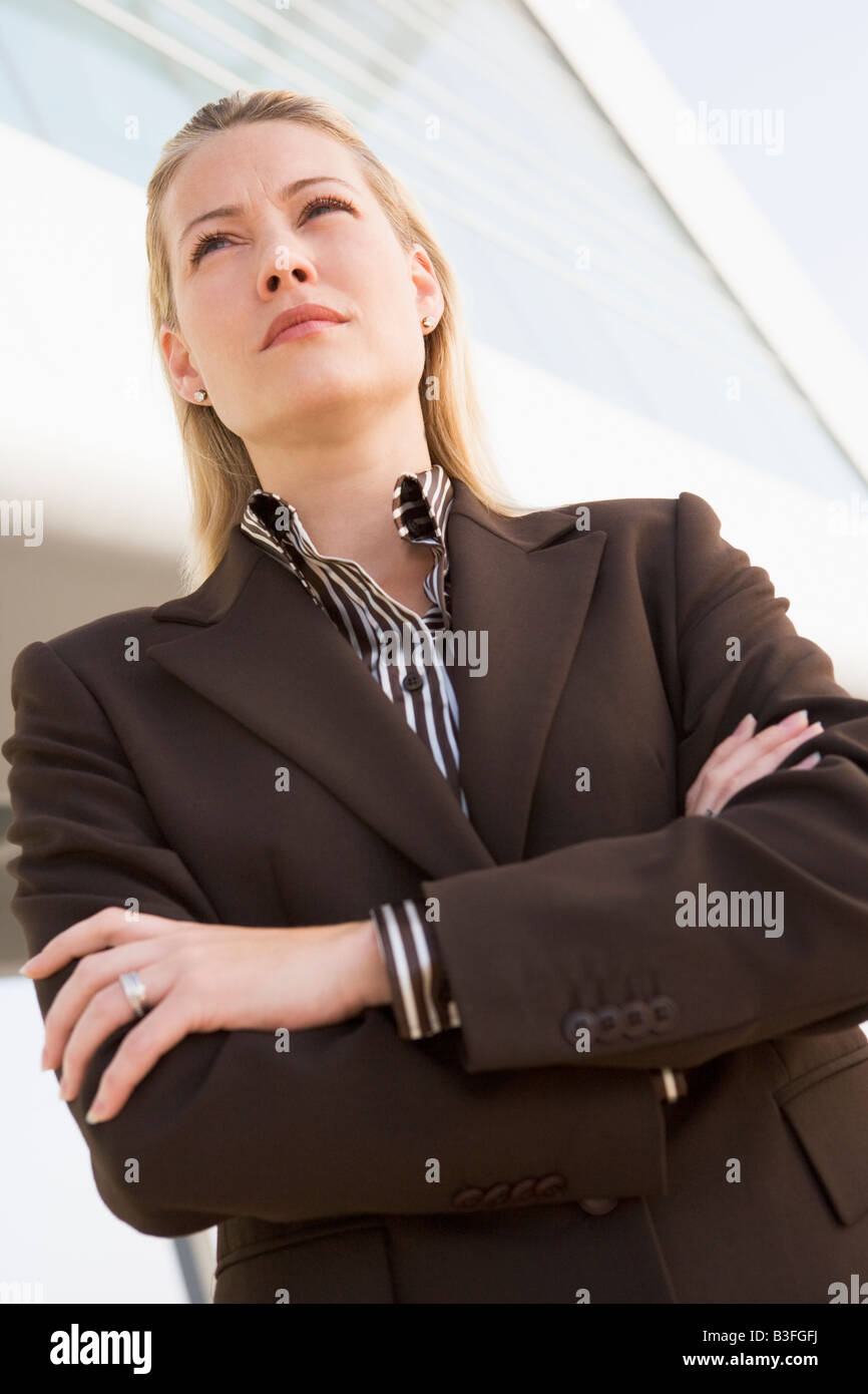 Businesswoman standing outdoors by building Stock Photo