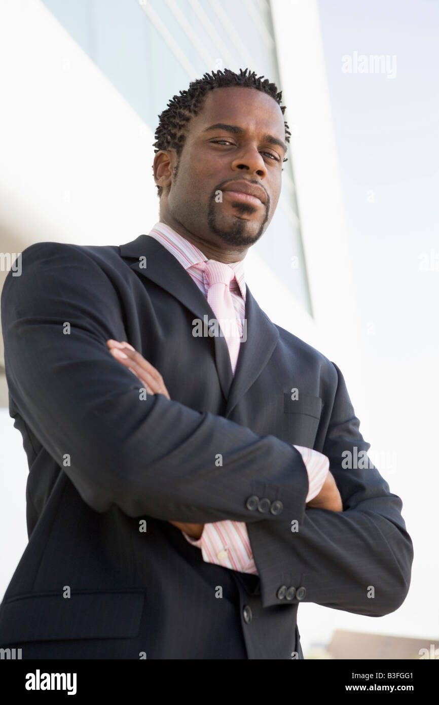 Businessman standing outdoors by building Stock Photo - Alamy