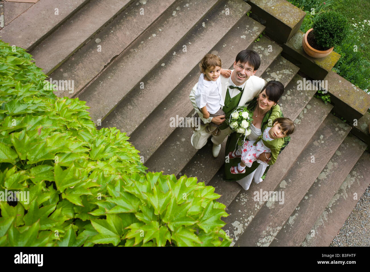 Bride and groom with their children son 3 years and daughter 4 years Stock Photo