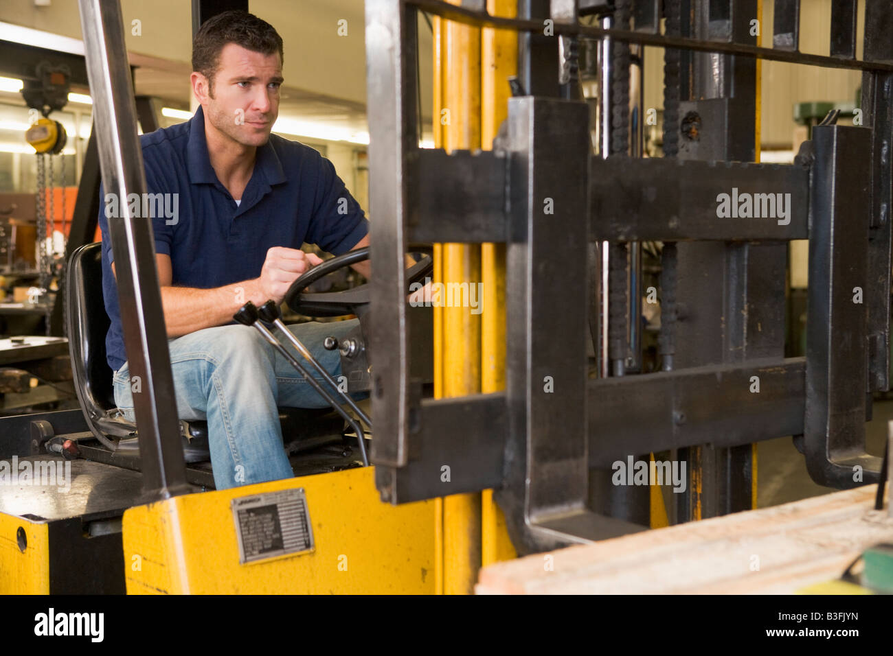 Warehouse worker in forklift Stock Photo Alamy
