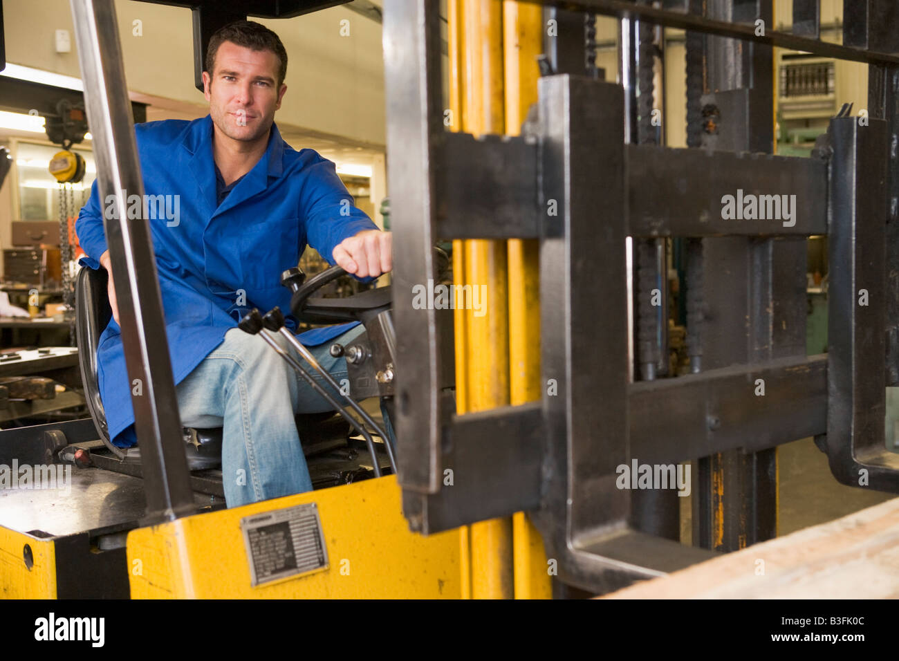 Warehouse worker in forklift Stock Photo Alamy