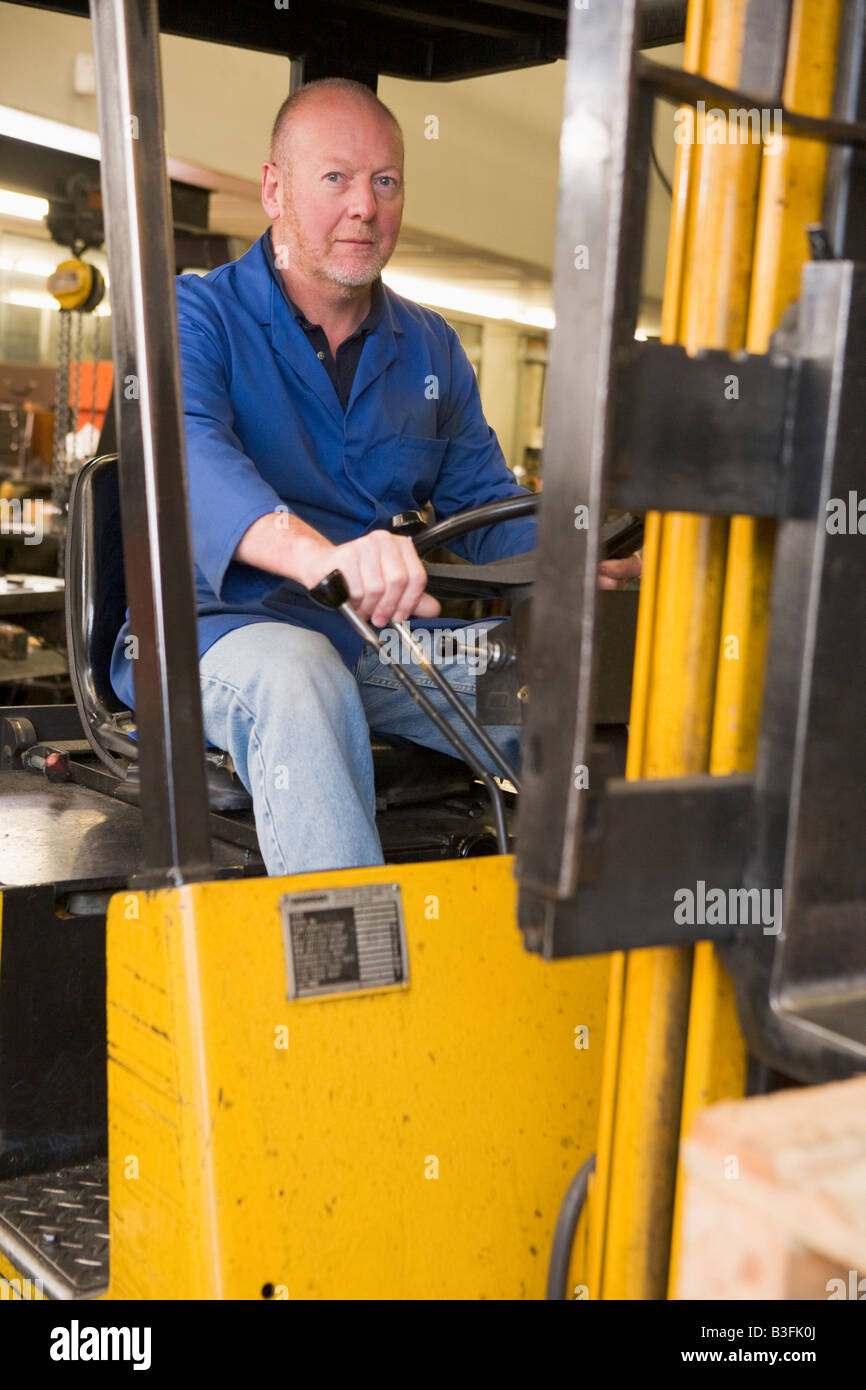 Warehouse worker in forklift Stock Photo Alamy