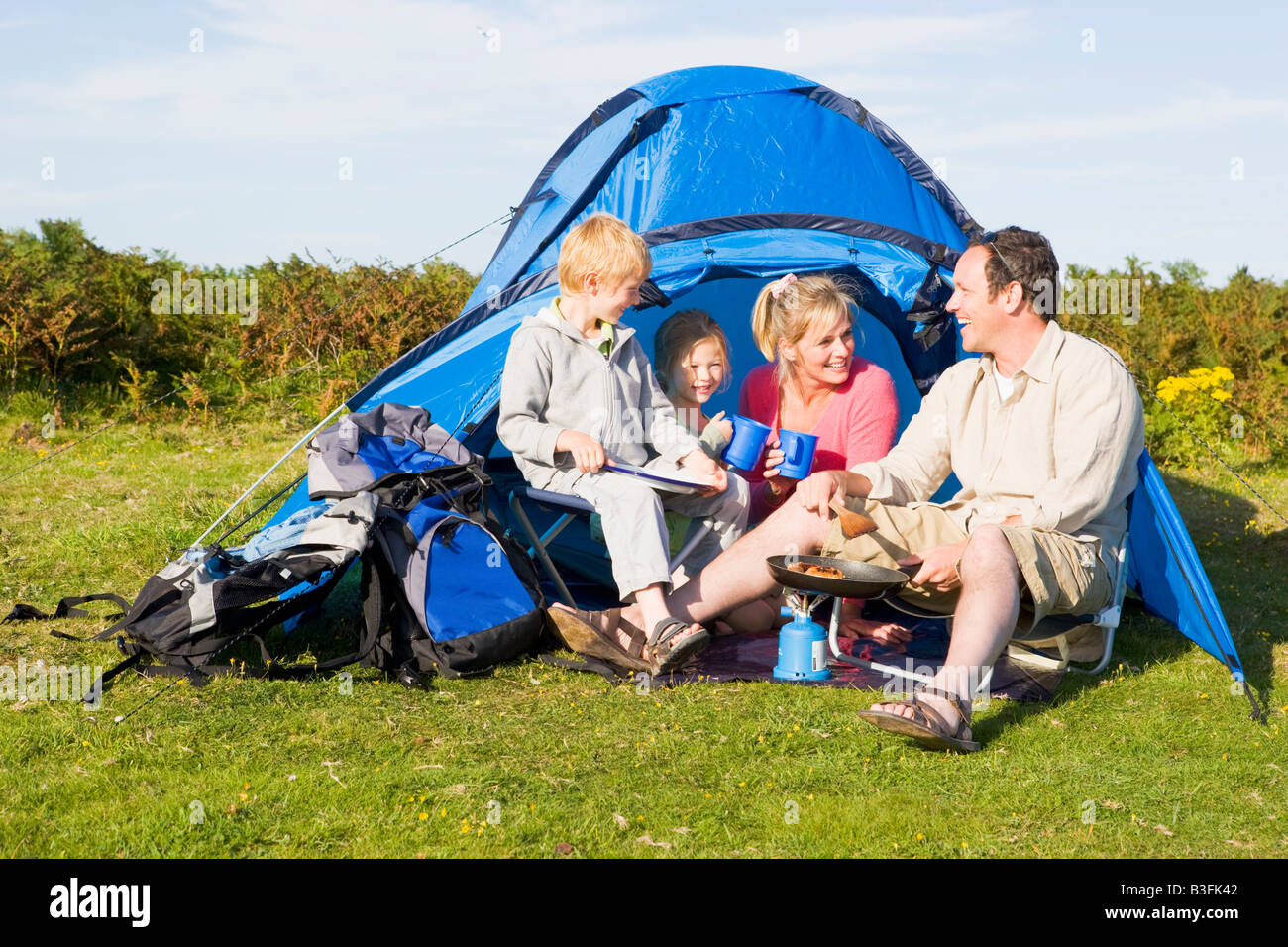 Family camping with tent and cooking Stock Photo