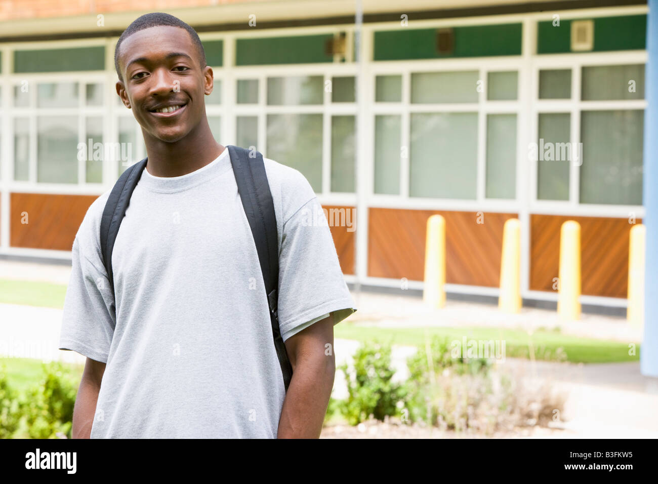 Student standing outdoors smiling Stock Photo