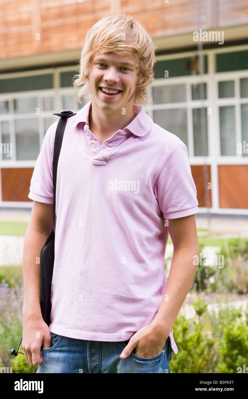 Student standing outdoors smiling Stock Photo - Alamy
