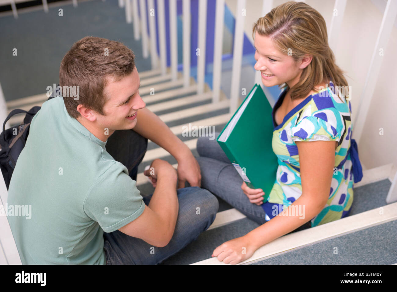 Two people sitting on stairs hi-res stock photography and images - Alamy