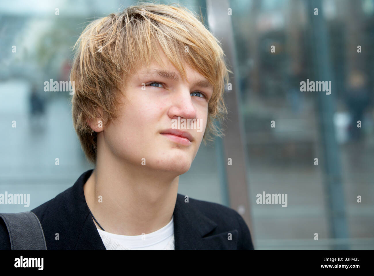 Portrait of teenage boy contemplating in urban environment Stock Photo ...