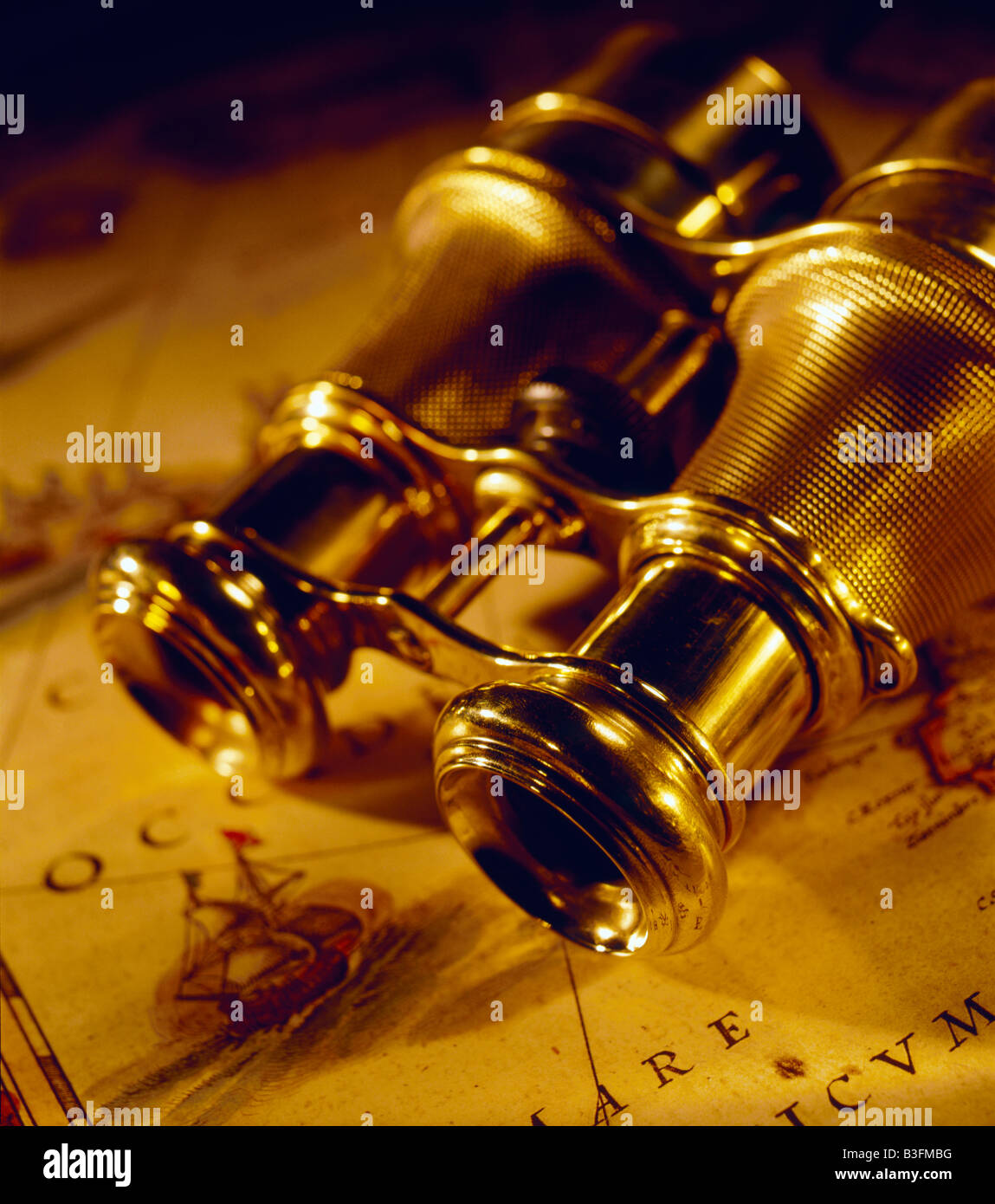 Old  Binoculars metal field glasses laying on antique map Stock Photo