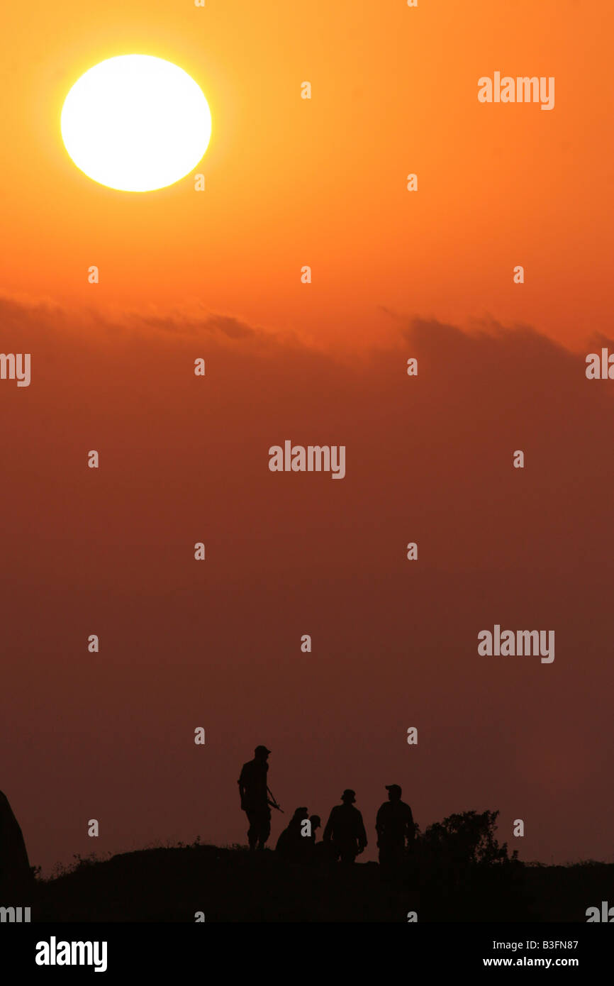 Israel Golan Heights silhouette of Israeli soldiers at sun set Stock Photo