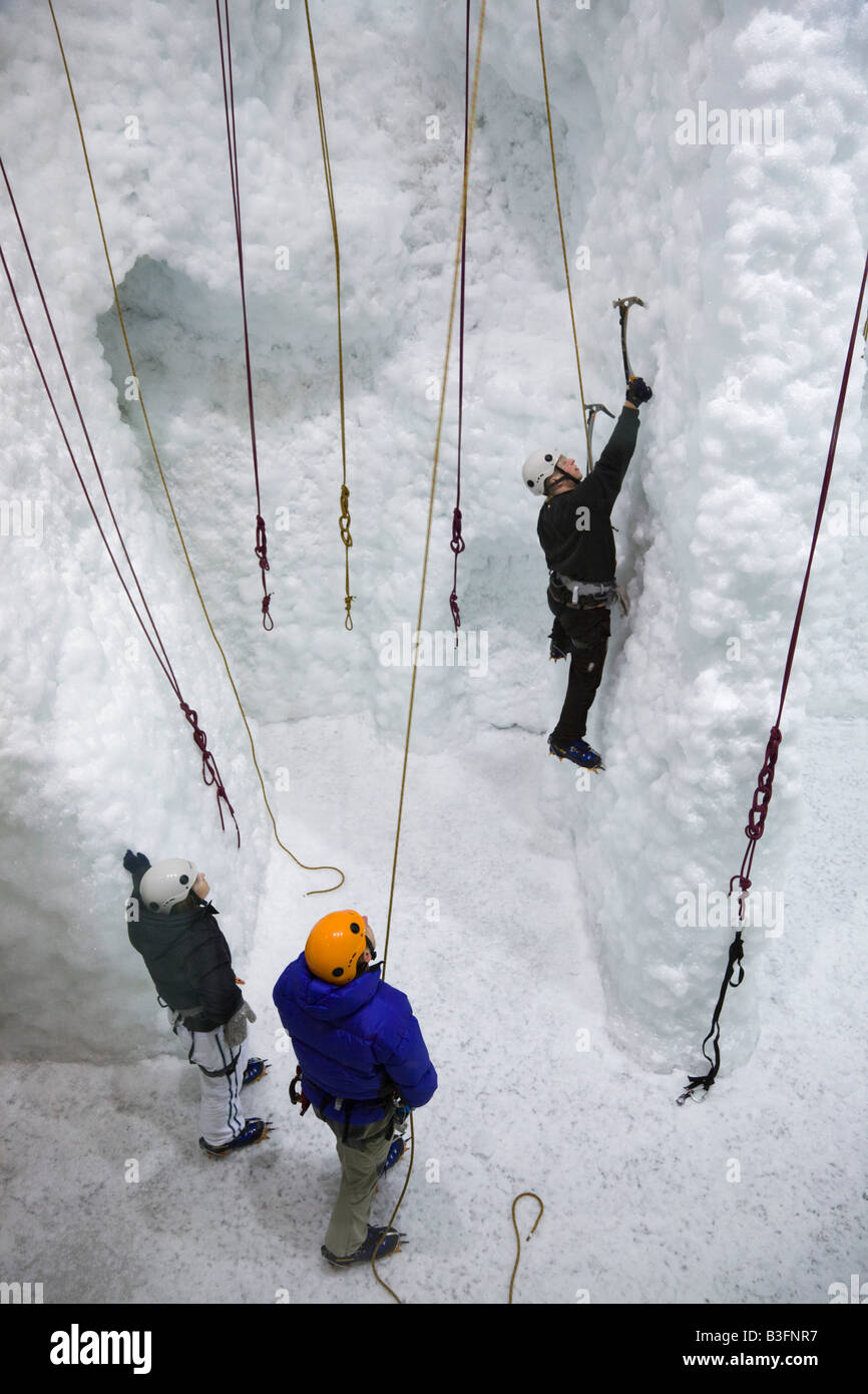 Hukawai indoor climate controlled ice climbing chamber with people training on indoor ice wall Franz Josef New Zealand Stock Photo