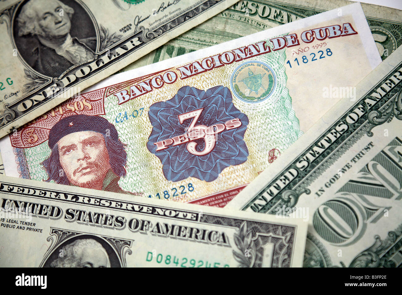 Che Guevara on a Cuban banknote with United States Dollars Stock Photo