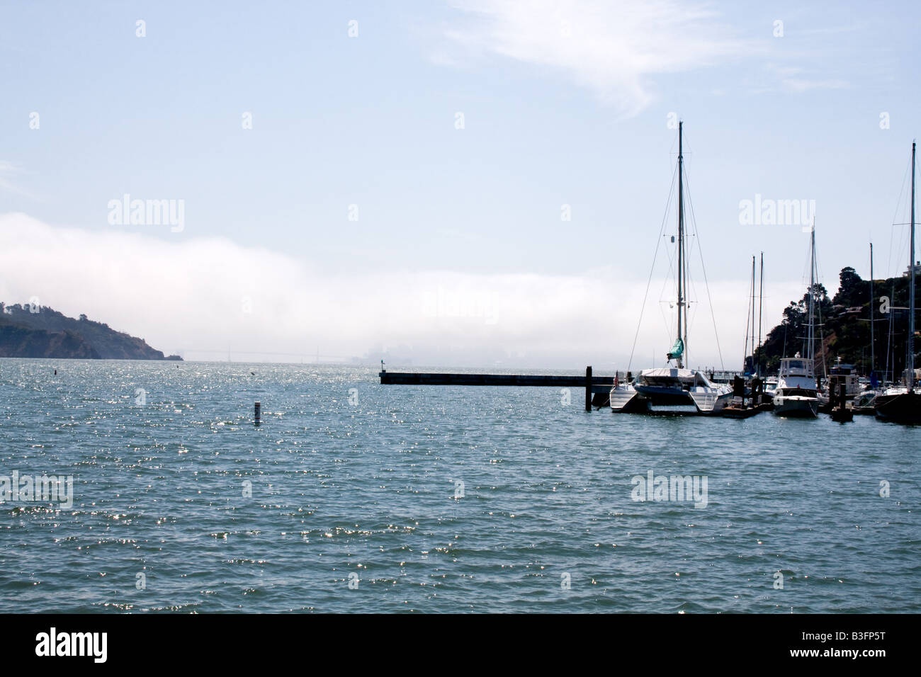 Boat in a bay with fog rolling in Tiburon, California Stock Photo
