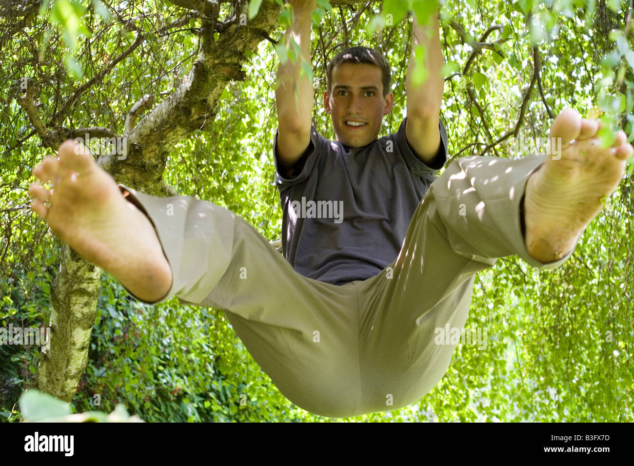 man climbing on the tree Stock Photo