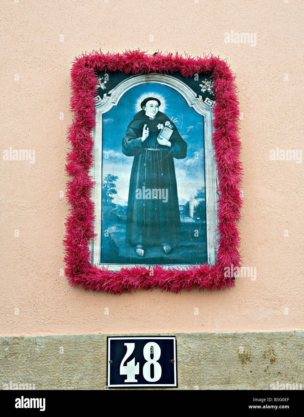 Saint painting on the facade wall in Alfama district Lisbon Portugal Stock Photo
