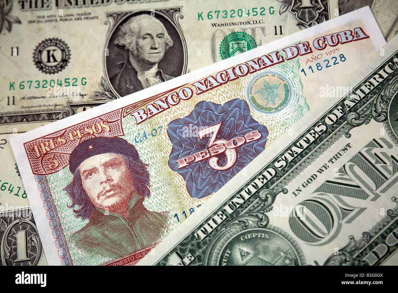 Che Guevara on a Cuban banknote with United States Dollars Stock Photo