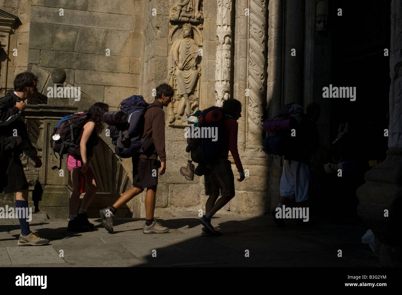 Pilgrims walk in Santiago de Compostela Cathedral WAY OF SAINT JAMES or CAMINO DE SANTIAGO -  GALICIA region SPAIN Stock Photo