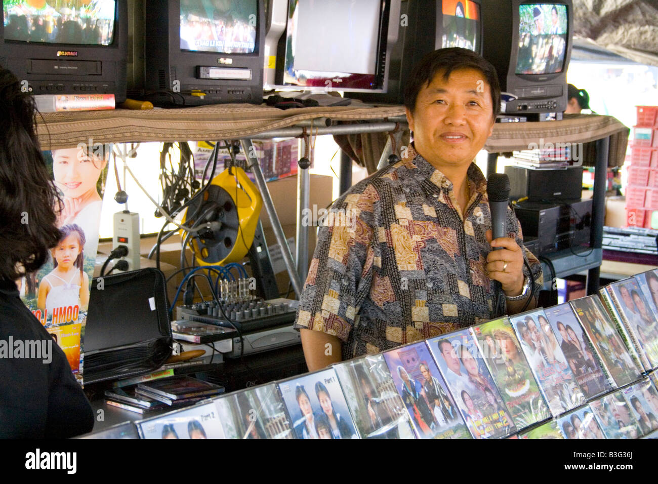 Hmong salesman age 40 selling Asian videos. Hmong Sports Festival McMurray Field St Paul Minnesota USA Stock Photo