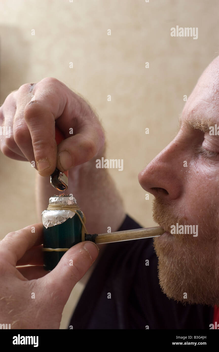 Man smoking a crack pipe Stock Photo