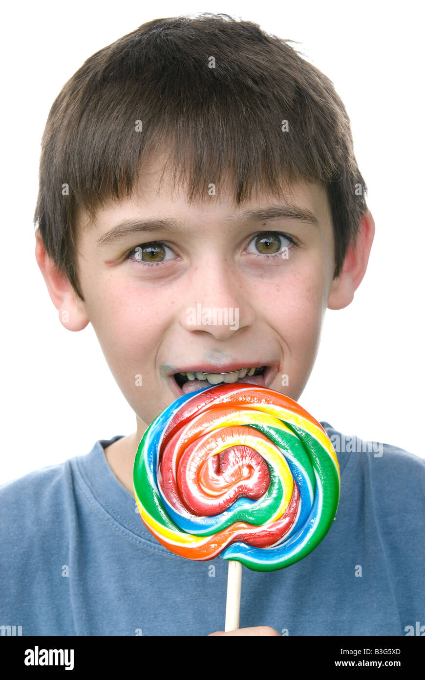 A boy enjoys his candy pin wheen sucker after a big dinner Stock Photo