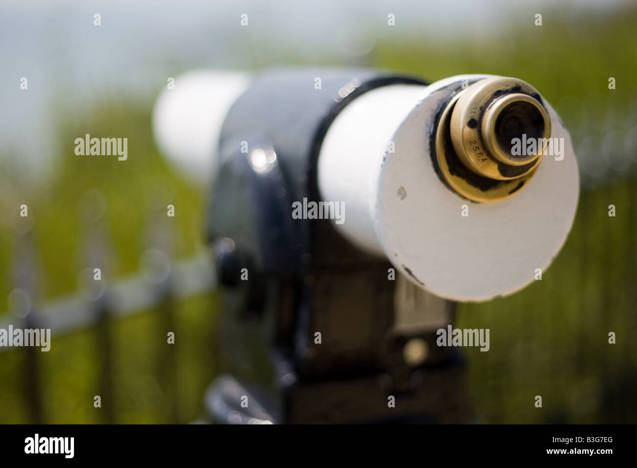 Tourist viewing scope looks out to sea with shallow depth of field Stock Photo