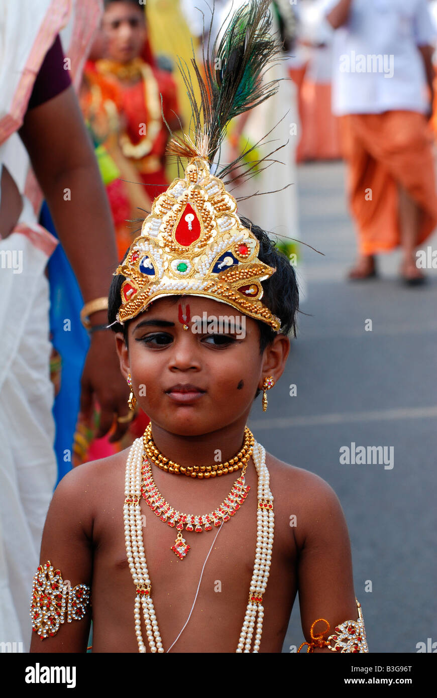 A boy posing as lord Krishna in a religious procession at Trivandrum
