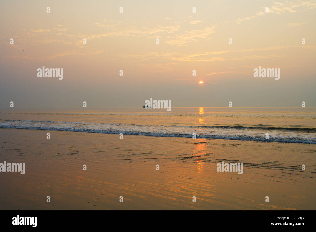 A shrimp boat works the shoreline as the sun rises over the Atlantic ocean  as seen from Cumberland Island. Georgia USA Stock Photo - Alamy