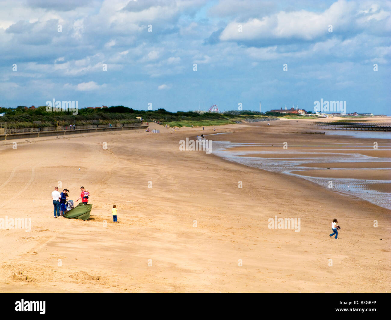 Family on Skegness beach in summer, Lincolnshire, England, UK Stock Photo