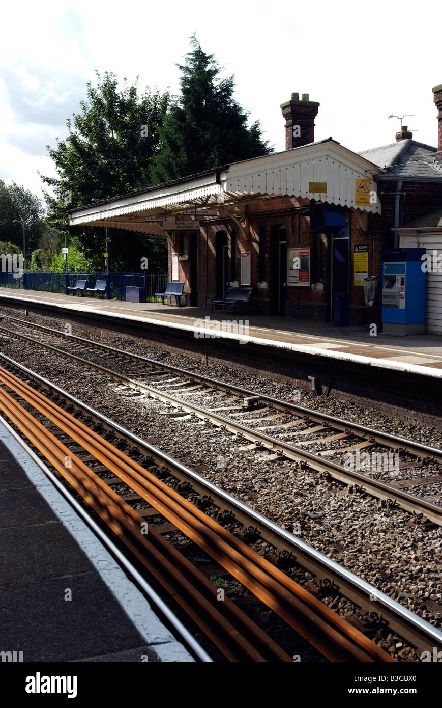 Rural railway station line with spare track stored between the rails Stock Photo