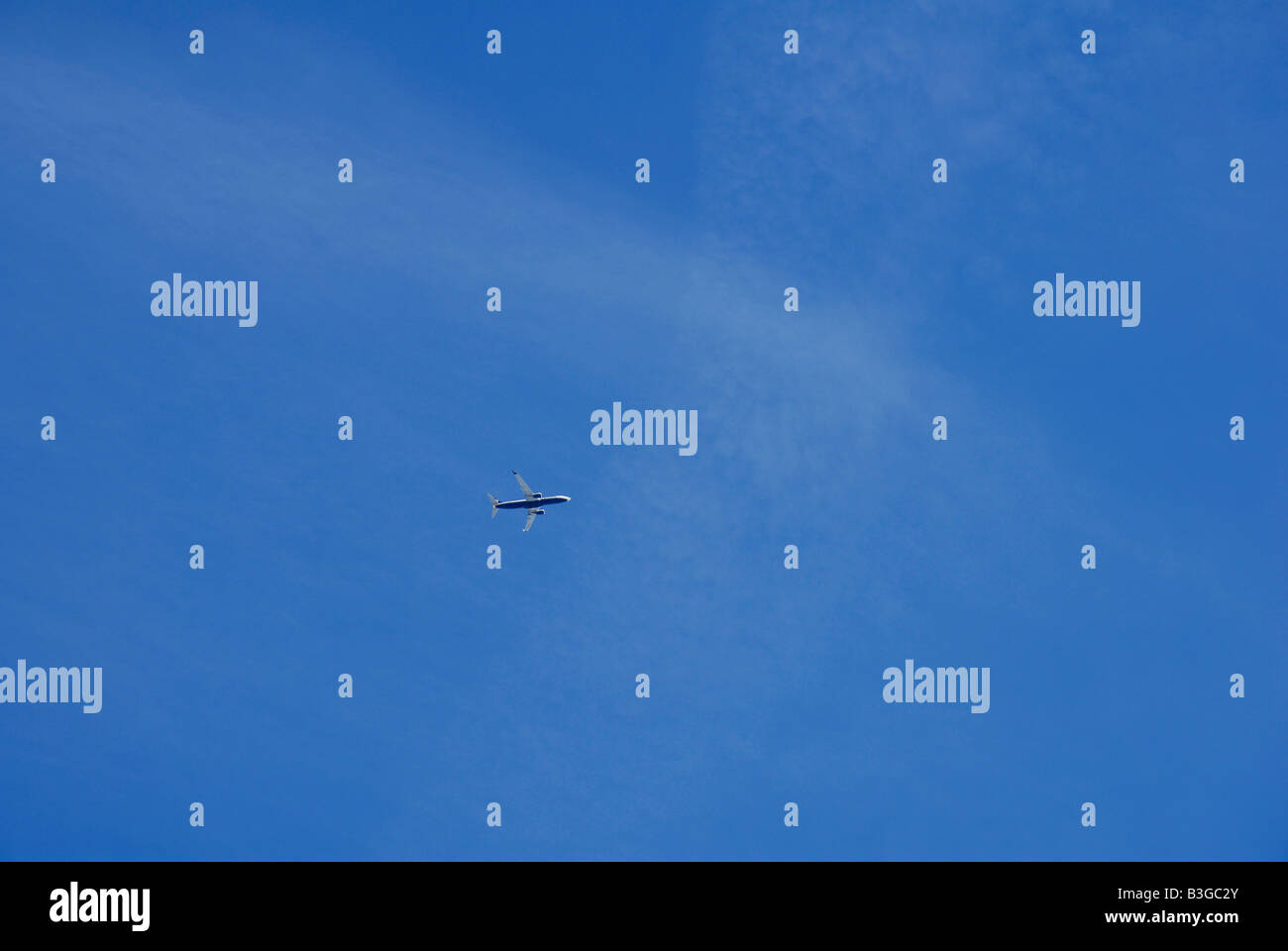 Plane in the blue sky Stock Photo - Alamy