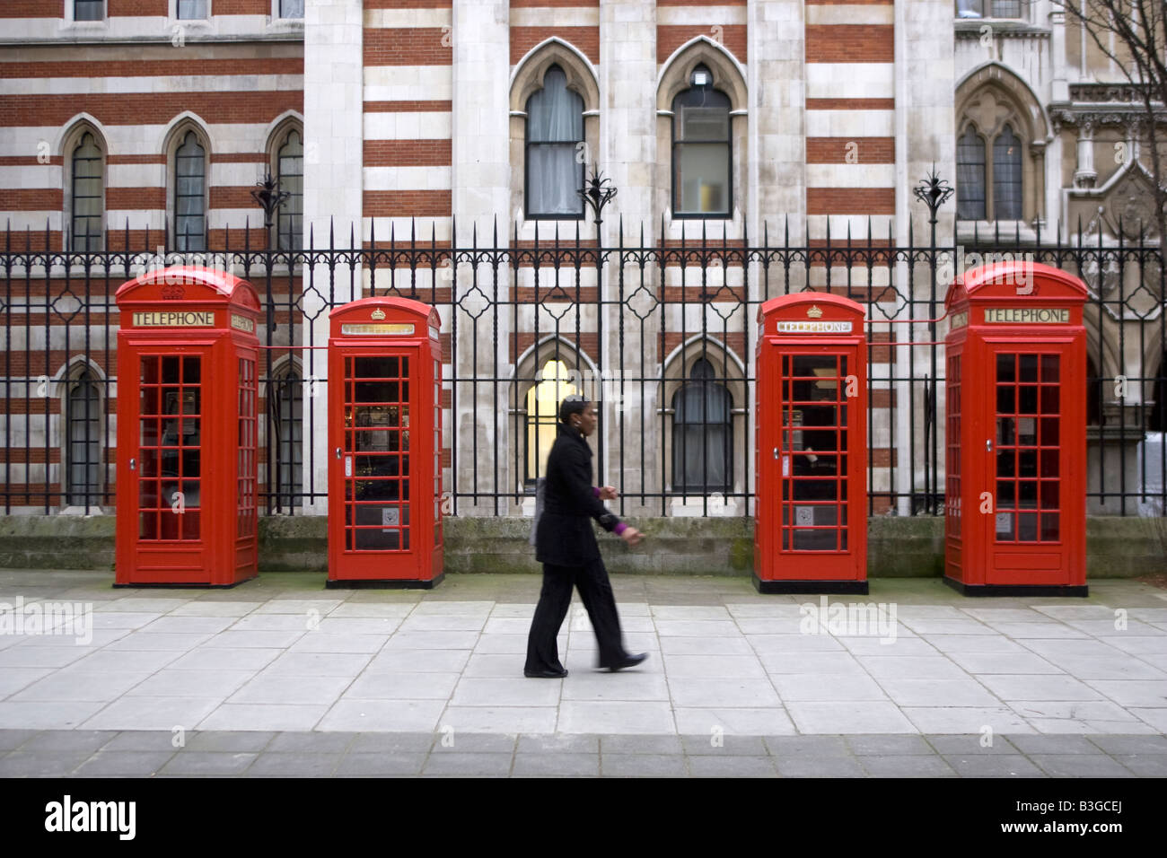 Four red telephone boxes in a row Stock Photo