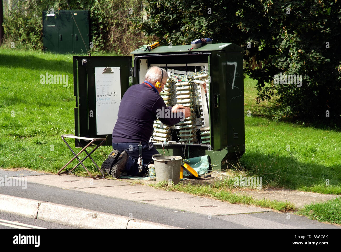 BT engineer on a junction box on the roadside England UK Stock Photo