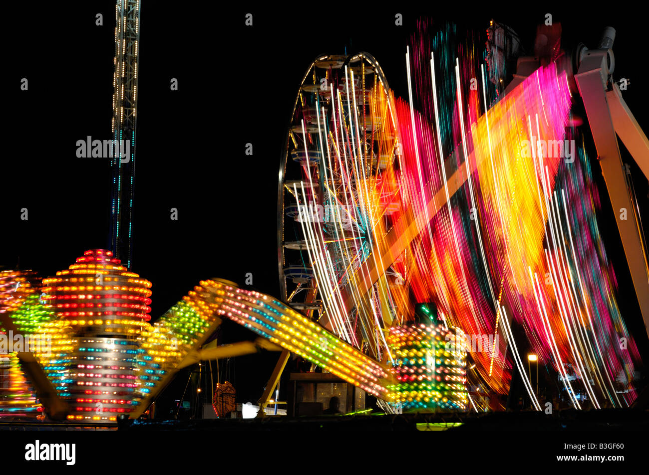 Amusement rides shining at night Stock Photo - Alamy