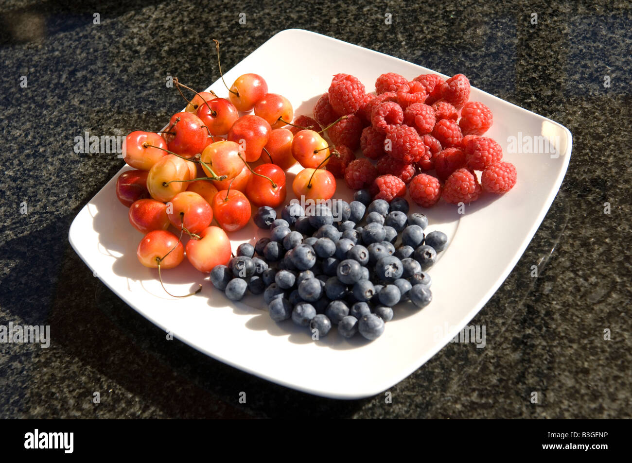Three summer fruits on a dish, UK Stock Photo