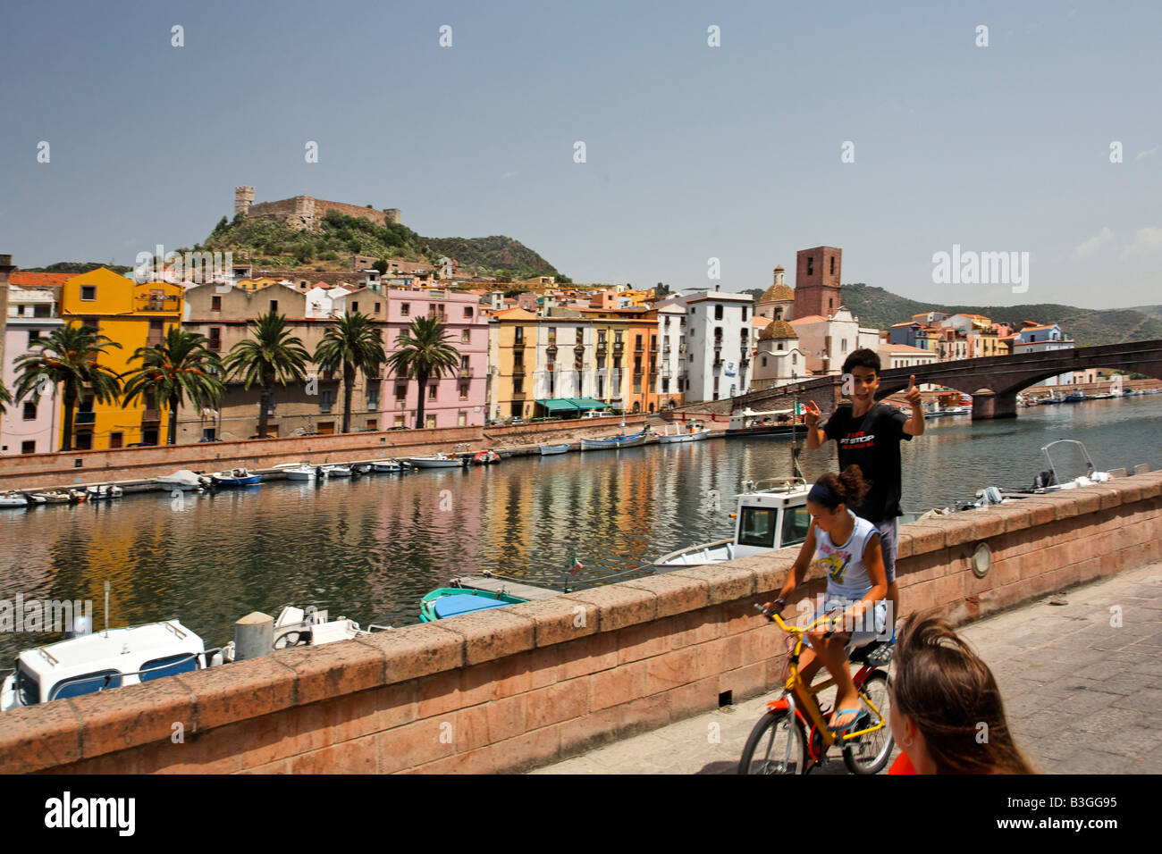 Italy Sardinia Bosa west coast canal children on bicycle Stock Photo