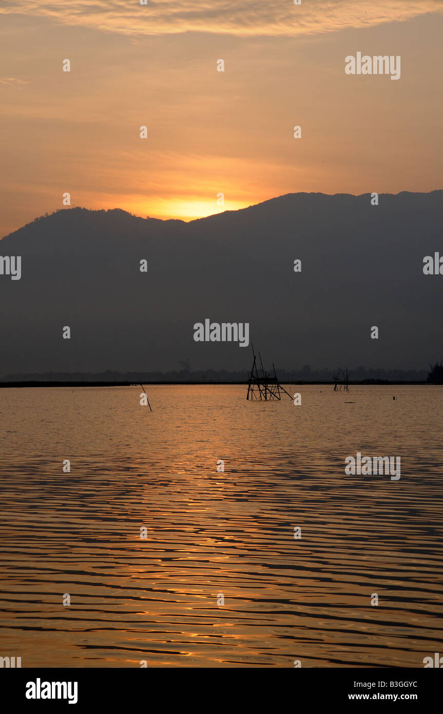 Sun rising over Lak Lake Vietnam Stock Photo - Alamy