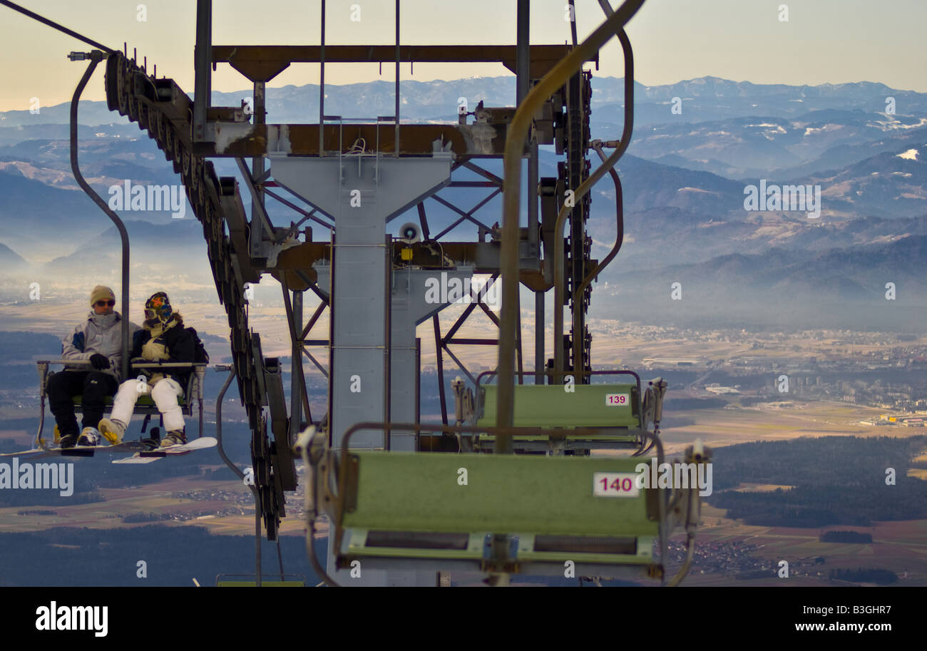 Two skiers riding a chair lift with beautiful backgroung Stock Photo ...