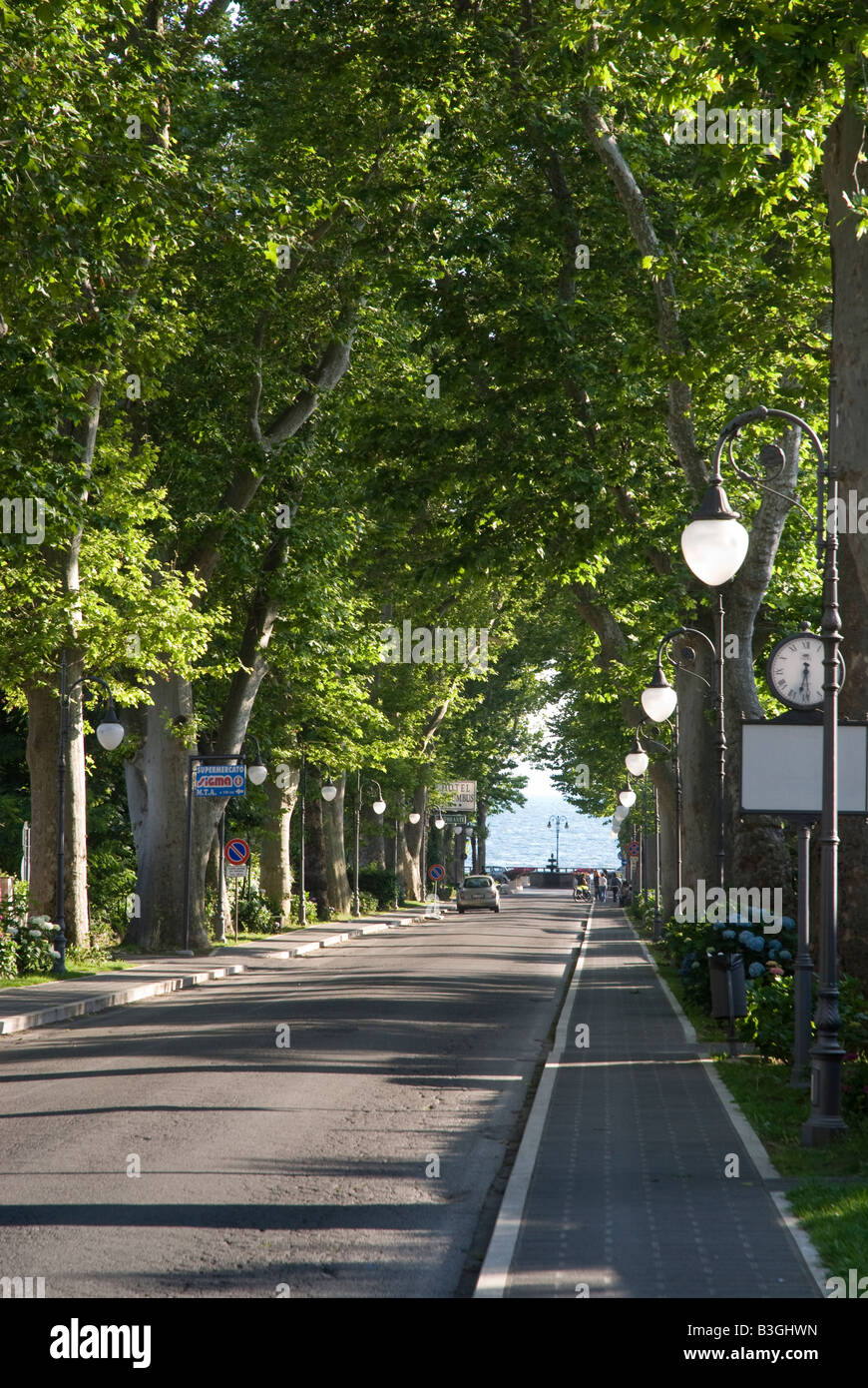 Lake side and tree lined avenue leading to the lake at Bolsena in Lazio, Italy Stock Photo