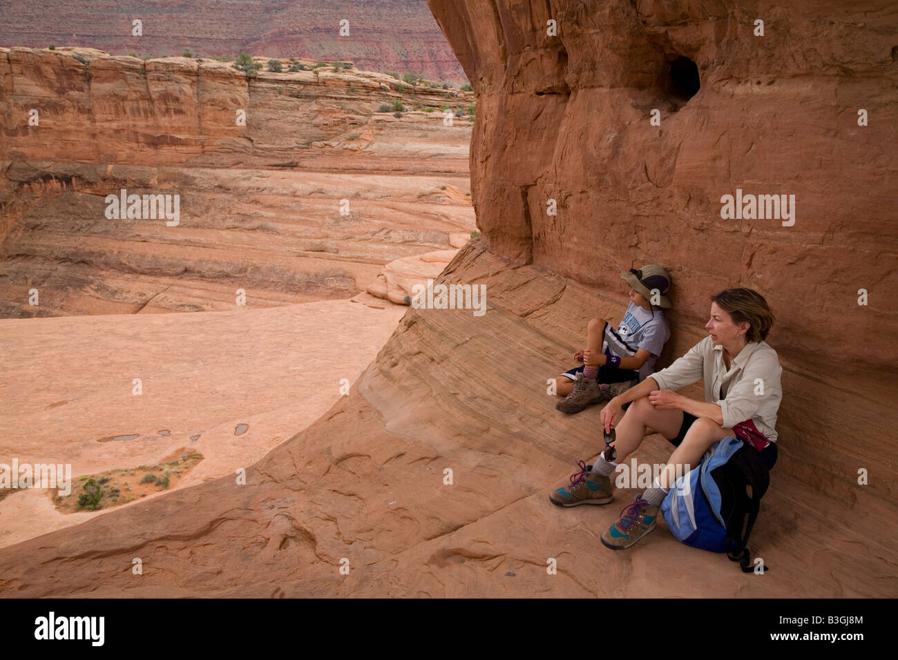 Moab Utah Arches National Park Linda Elliott and her son Joey West 9 rest while hiking near Delicate Arch Stock Photo