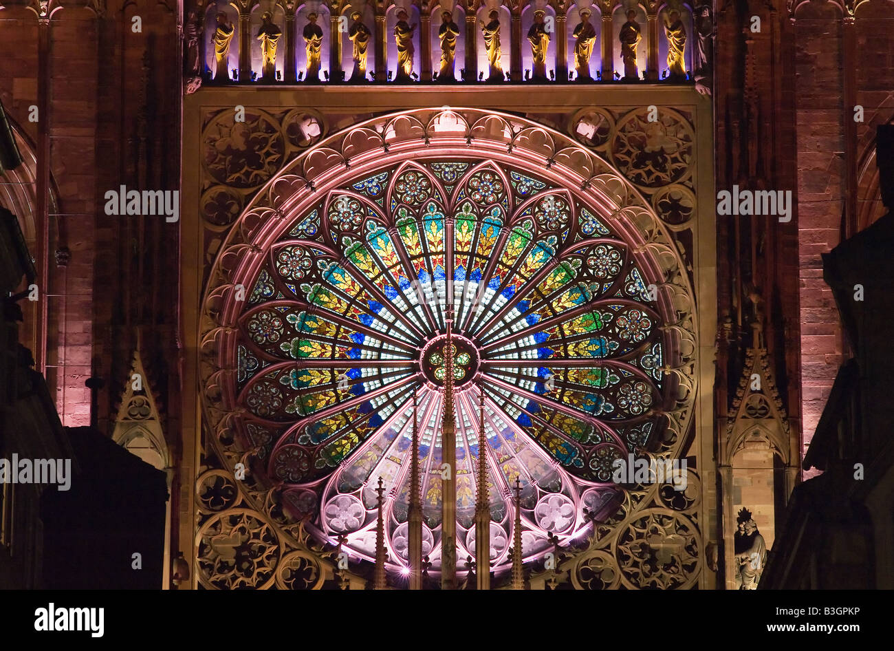 Illuminated rose window of Notre-Dame gothic cathedral 14th century at night, Strasbourg, Alsace, France, Europe Stock Photo