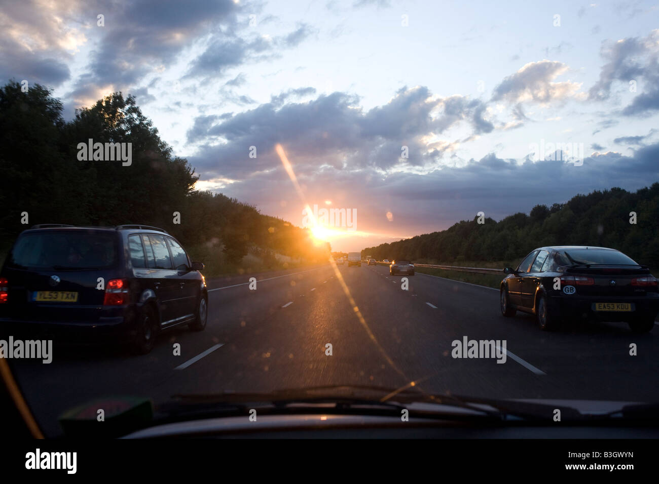Driving into a setting sun while overtaking in the middlelane with
