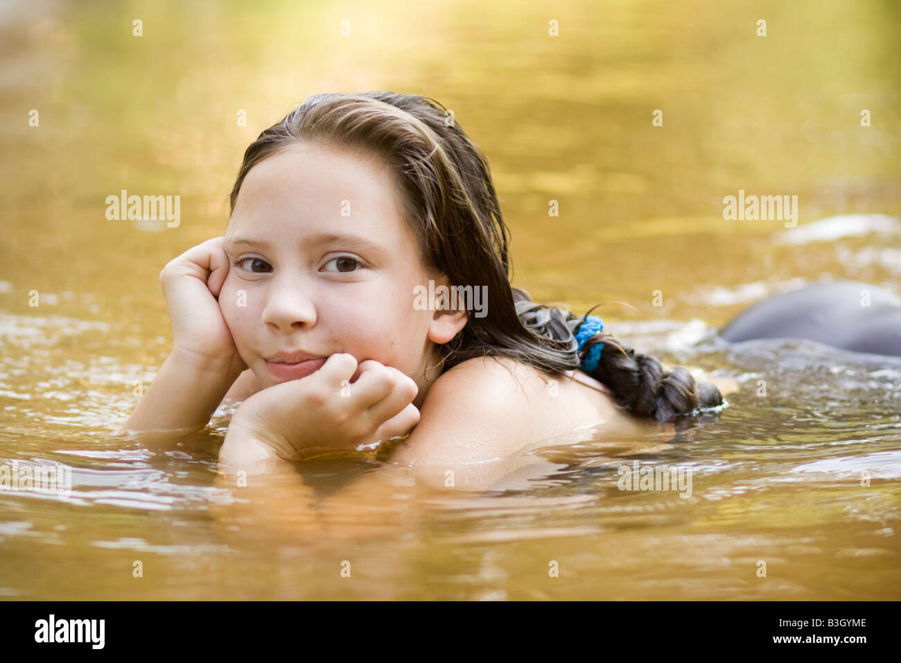 Teenage girl swimming in river Stock Photo - Alamy