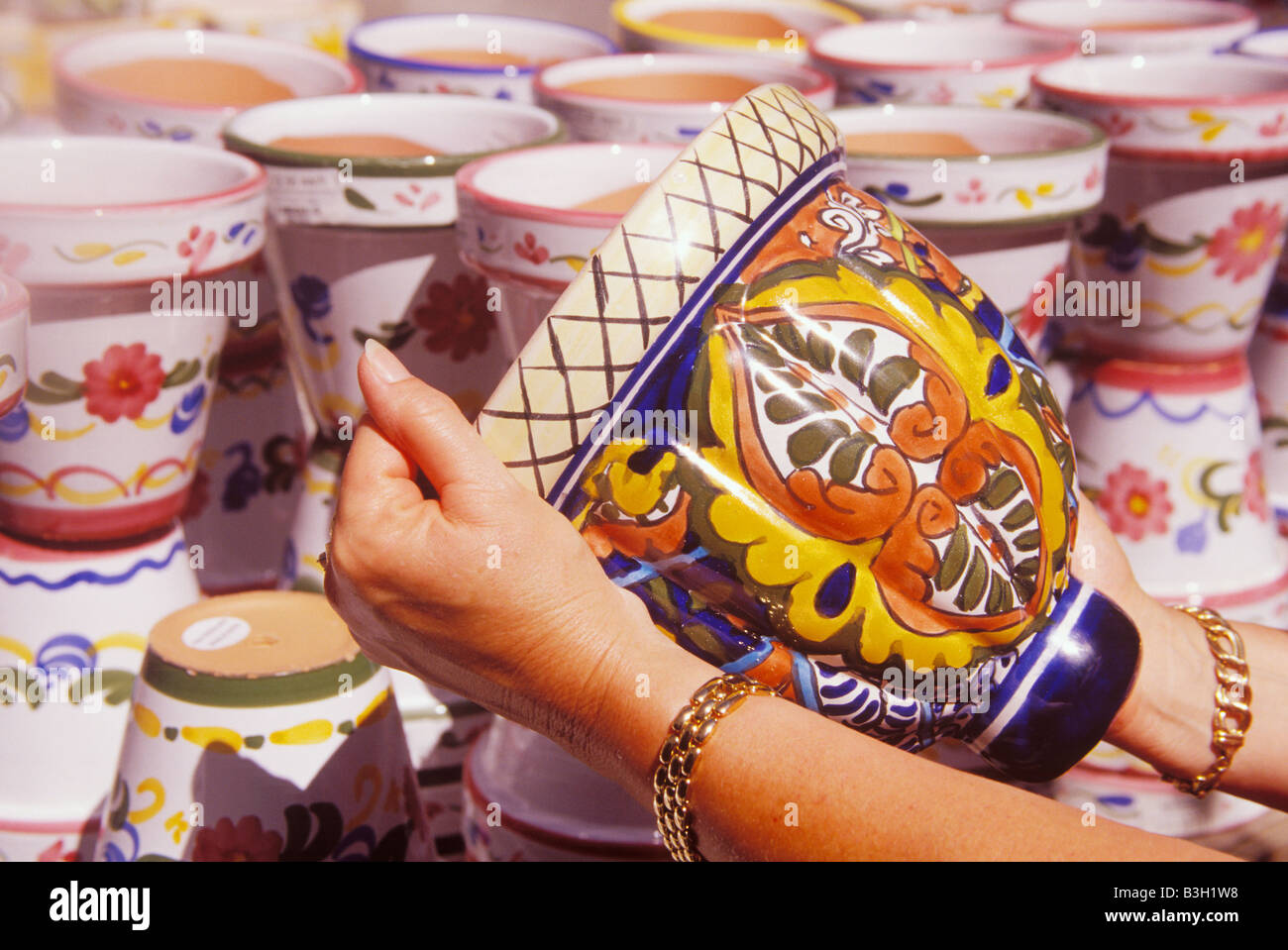 woman selecting Spanish pottery Colonial Spanish Quarter of St Augustine Florida Stock Photo