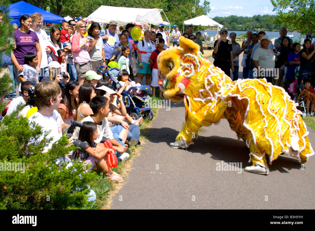 Dancing dragon performing in front of attentive audience. Dragon Festival Lake Phalen Park St Paul Minnesota USA Stock Photo