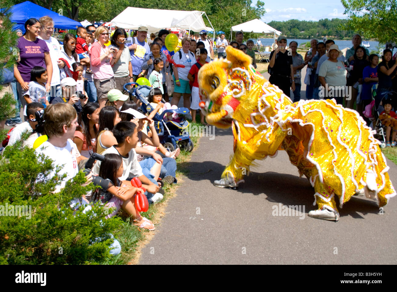 Dancing dragon performing in front of attentive audience. Dragon