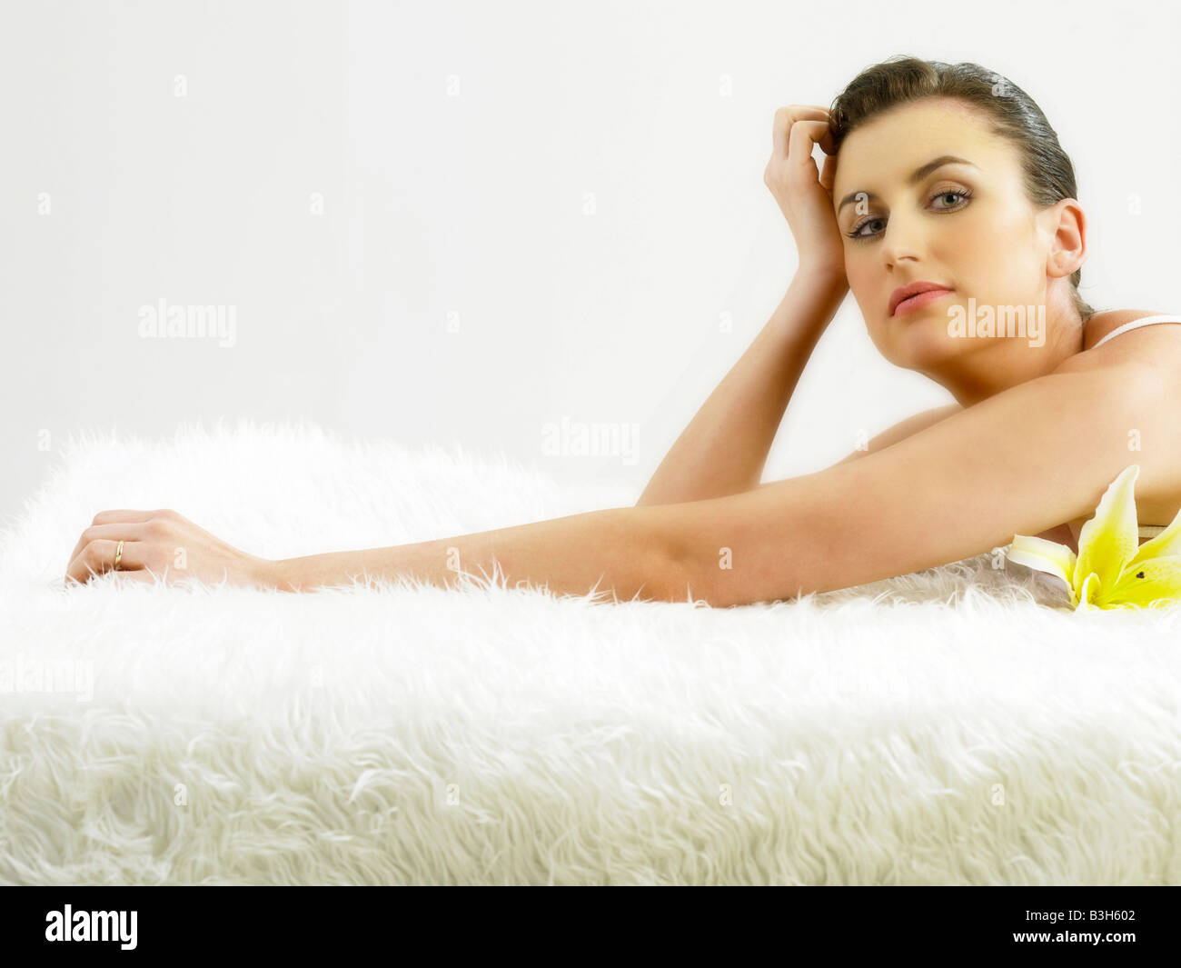 Young woman laying on carpet Stock Photo - Alamy