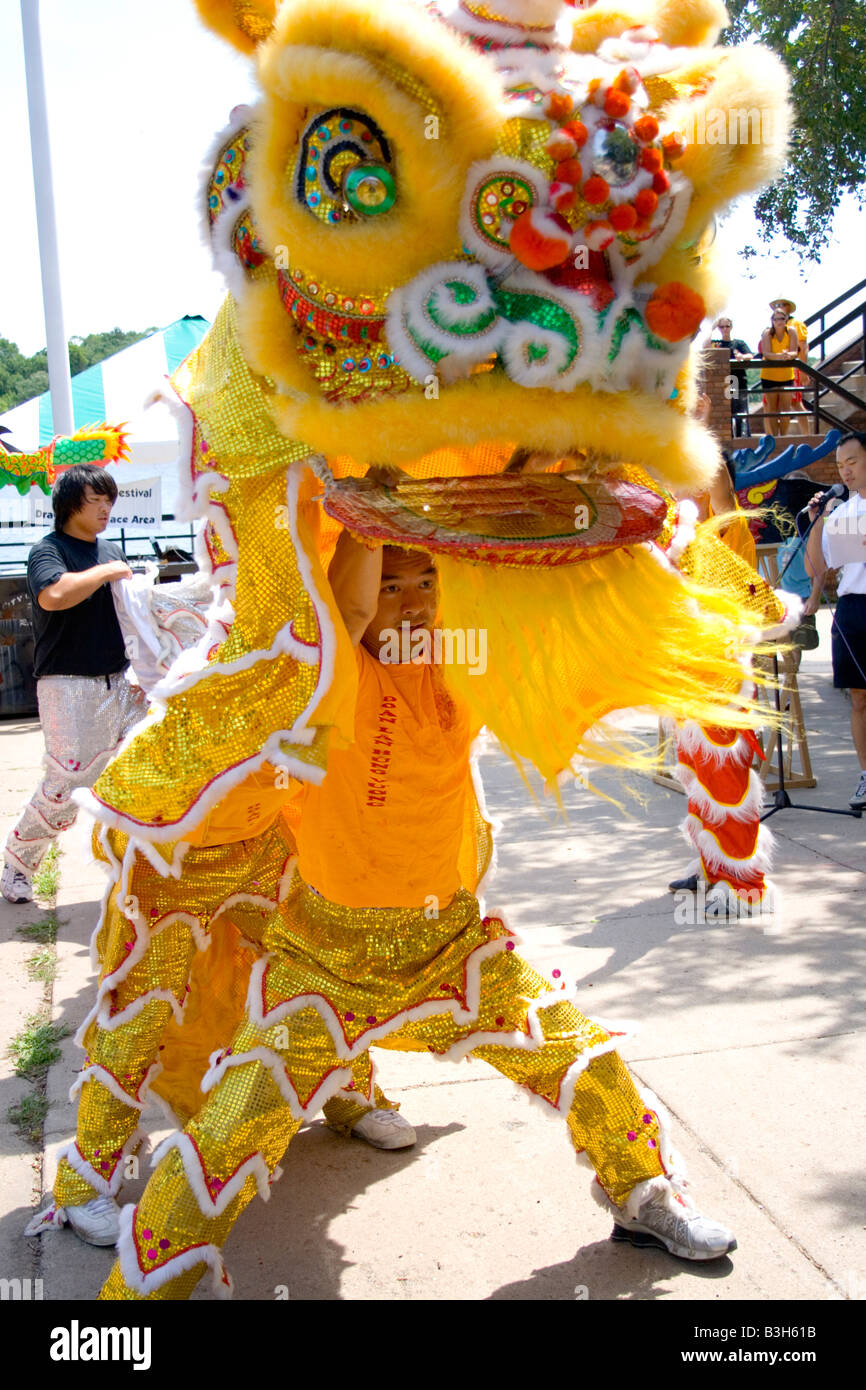 Asian dancers perform energetic dragon ceremony. Dragon Festival Lake